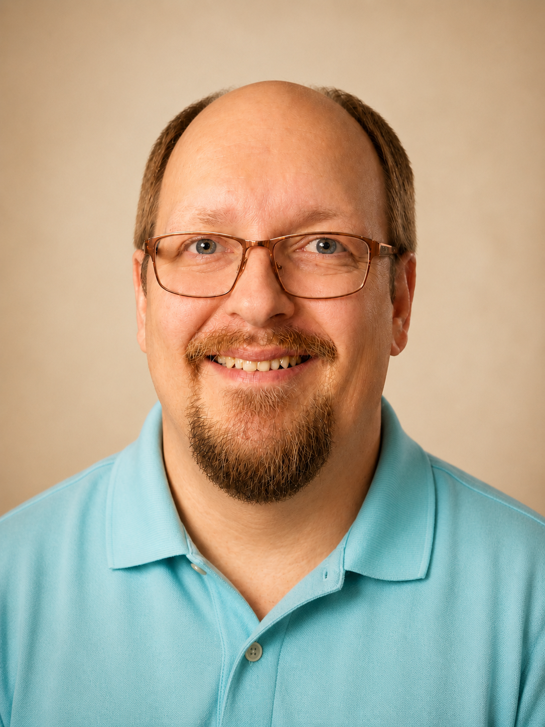 Author C.L. Johnson smiling in a studio portrait.